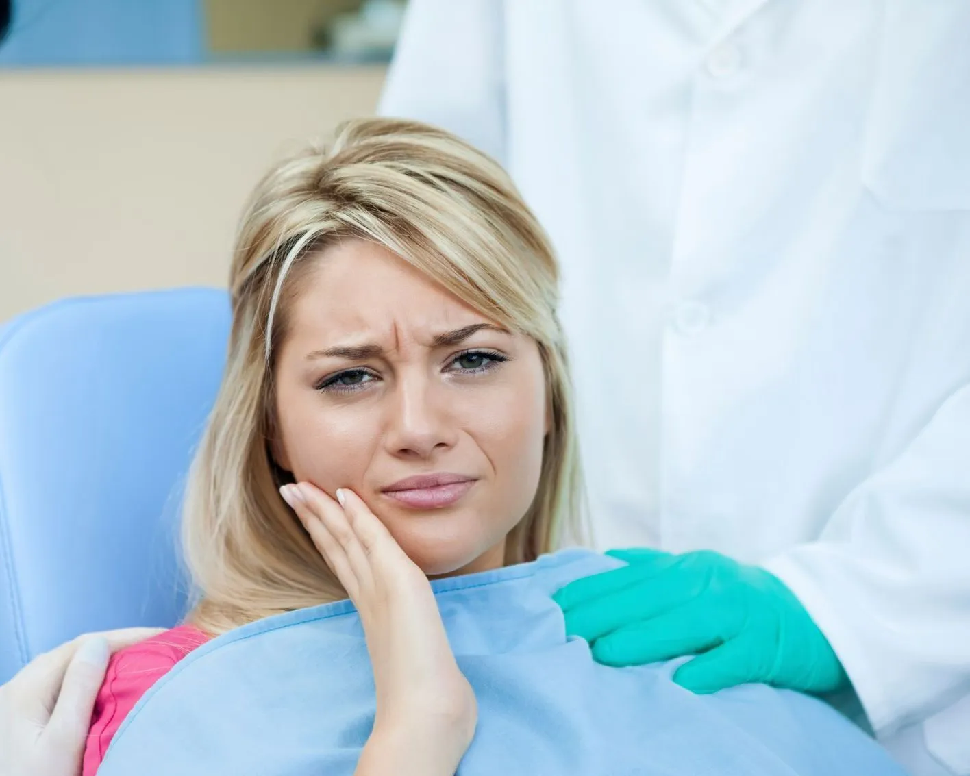 Alcan Family Dental helping a woman with a toothache during an emergency dental visit in Anchorage, 
